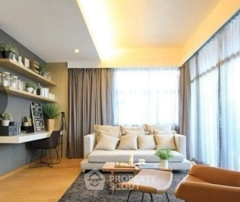 Modern living room with cozy seating and natural light, featuring stylish decor and a workspace.