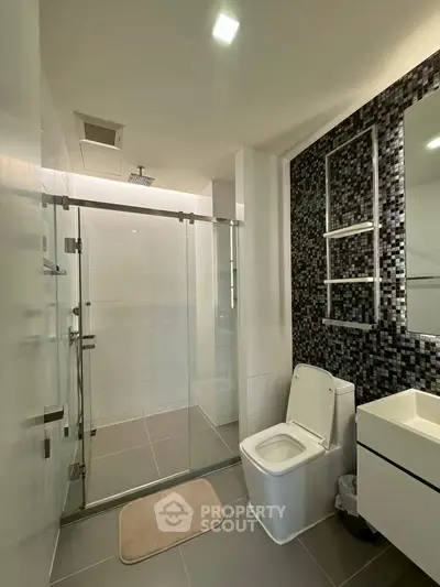 Modern bathroom with glass shower and sleek tile design