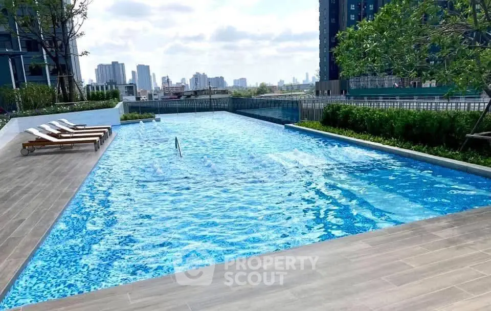 Luxurious rooftop pool with city skyline view, perfect for relaxation and leisure in a modern urban setting.