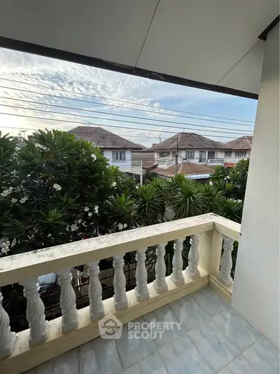 Charming balcony with scenic neighborhood view and lush greenery