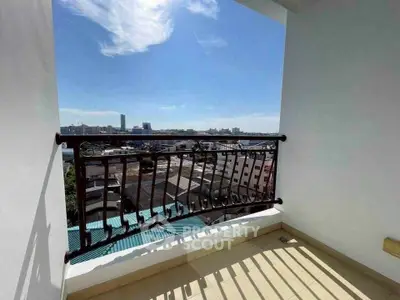 Stunning balcony view with cityscape and clear blue sky, perfect for relaxation.