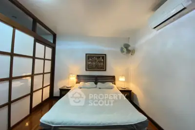 Cozy bedroom with modern decor and air conditioning in a stylish apartment.