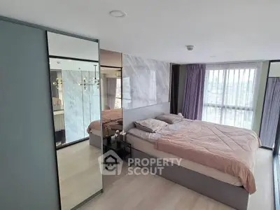 Spacious modern bedroom with large windows and stylish decor