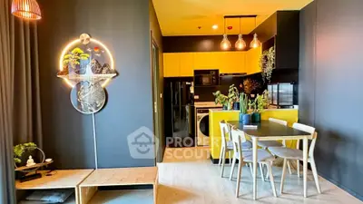 Modern open-layout kitchen and dining area with vibrant yellow cabinets and stylish decor.