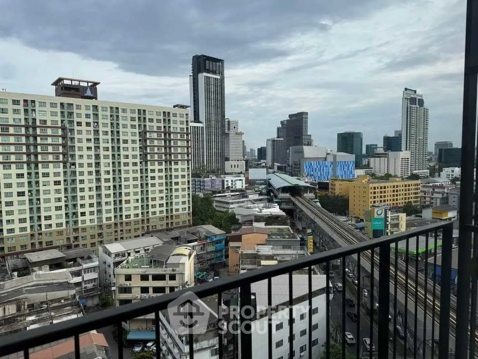 Stunning cityscape view from a high-rise balcony overlooking urban skyline.