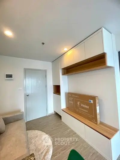 Modern living room with sleek built-in storage and natural light