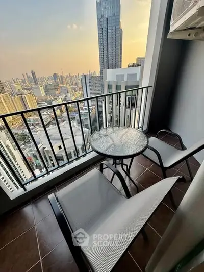 Stunning high-rise balcony with cityscape view, perfect for relaxation and enjoying sunsets.