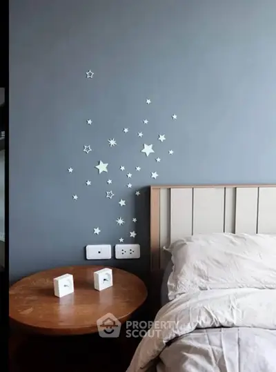 Cozy bedroom with star decals and modern wooden nightstand