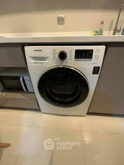 Modern kitchen with built-in Samsung washing machine and microwave.