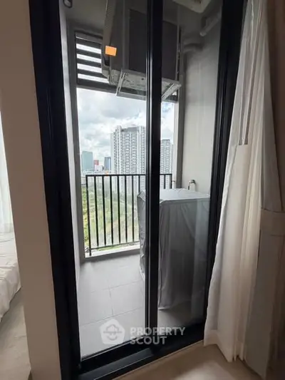 Modern apartment balcony with city view and air conditioning unit.