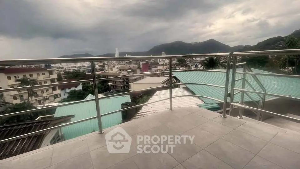 Stunning balcony view with mountains and cityscape, perfect for relaxation and enjoying the scenery.