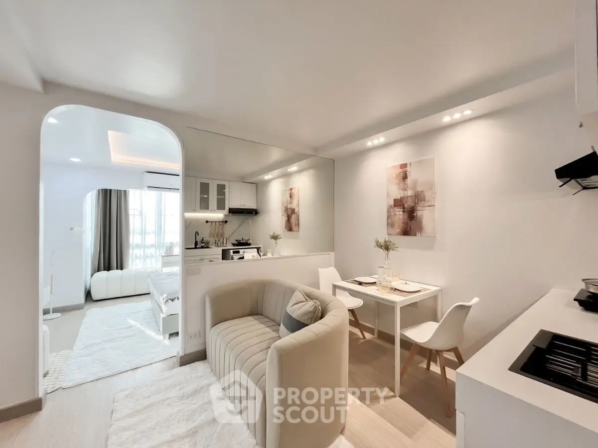 Modern open-plan living room with cozy seating and stylish dining area