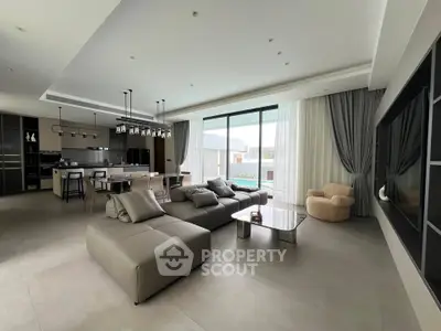 Luxurious open-plan living room with modern furniture and large windows