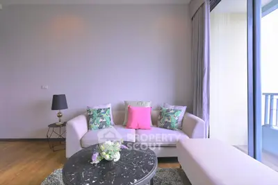 Stylish living room with modern decor and balcony view, perfect for urban living.