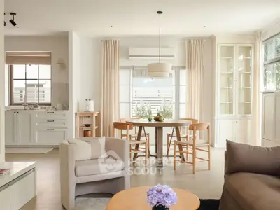 Charming open-plan living room with elegant dining area and natural light