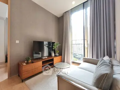 Modern living room with stylish furniture and large window for natural light.