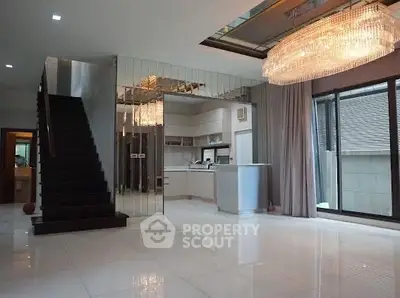 Luxurious modern living room with elegant chandelier and mirrored wall