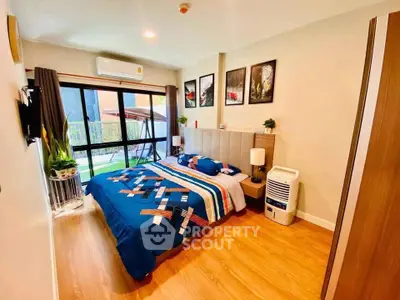 Modern bedroom with stylish decor and large window overlooking garden.