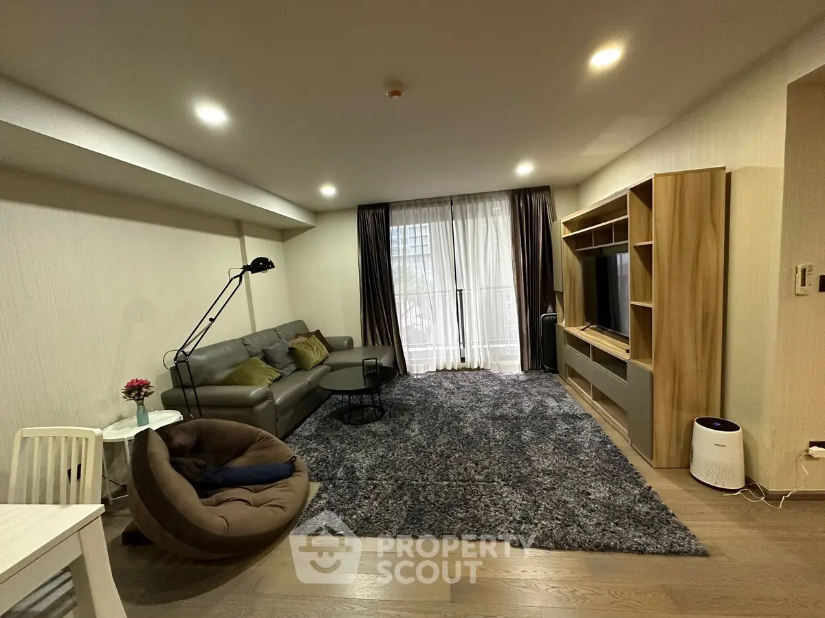 Spacious modern living room with cozy seating and entertainment center