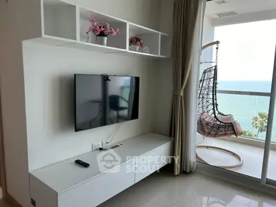 Modern living room with ocean view and stylish hanging chair on balcony