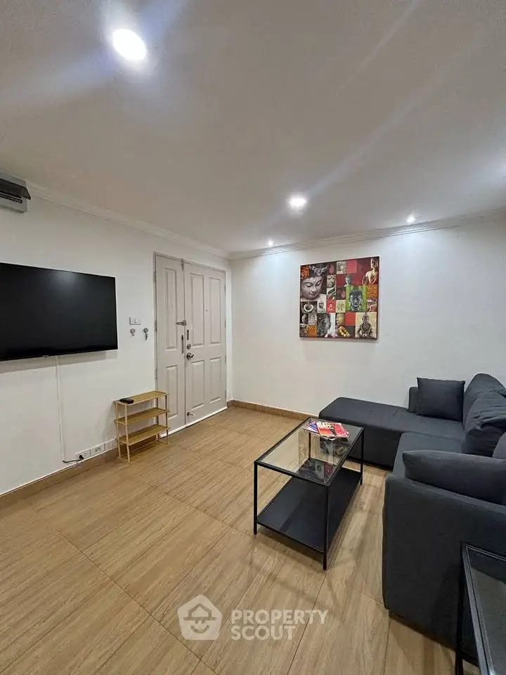 Modern living room with sleek furniture and wall-mounted TV