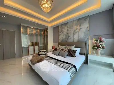 Luxurious bedroom with elegant decor and modern lighting in a stylish home.