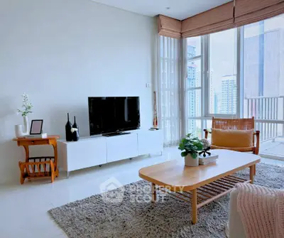 Bright modern living room with large windows and stylish furniture.