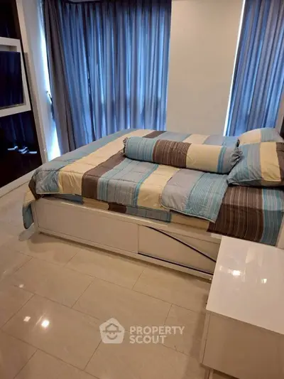 Cozy bedroom with modern decor and ample natural light