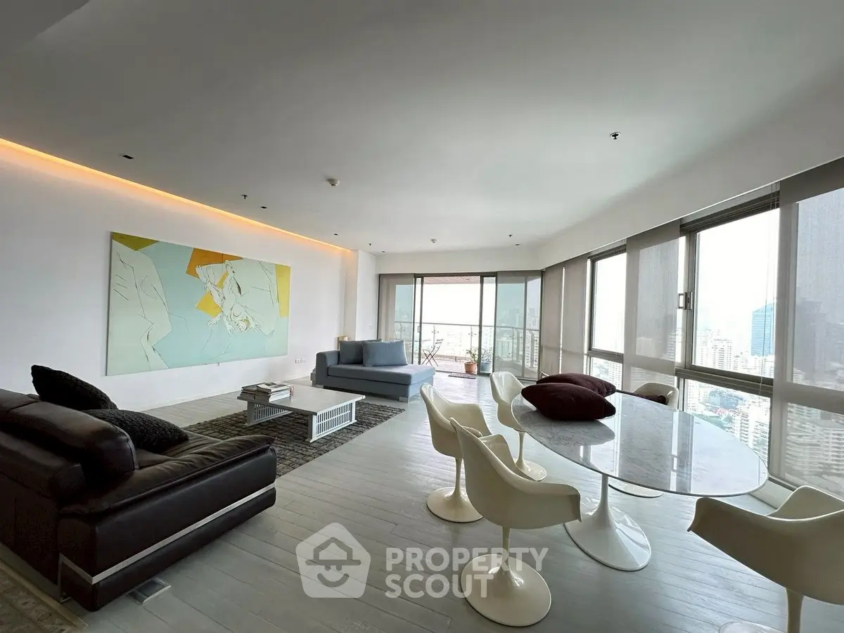 Spacious modern living room with panoramic city views and stylish furniture.