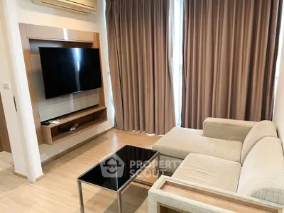 Modern living room with sleek TV setup and cozy beige sofa, perfect for relaxation.