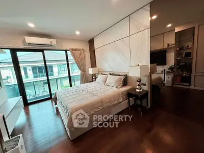 Luxurious bedroom with elegant decor and large windows offering a serene view, perfect for relaxation.