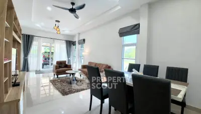 Spacious modern living and dining area with elegant furnishings and natural light.