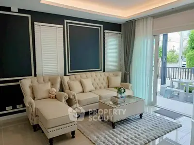 Elegant living room with plush seating and modern decor, featuring large windows and abundant natural light.