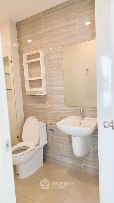 Modern bathroom with sleek fixtures and neutral tile design