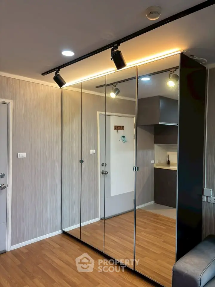 Modern living room with mirrored wardrobe and stylish lighting