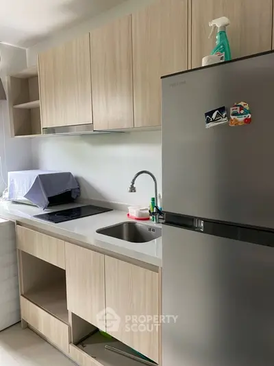 Modern kitchen with sleek cabinetry and stainless steel fridge