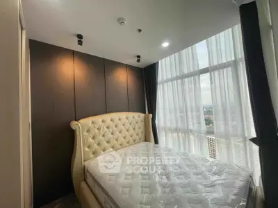 Luxurious bedroom with elegant bed and panoramic city view through large window.