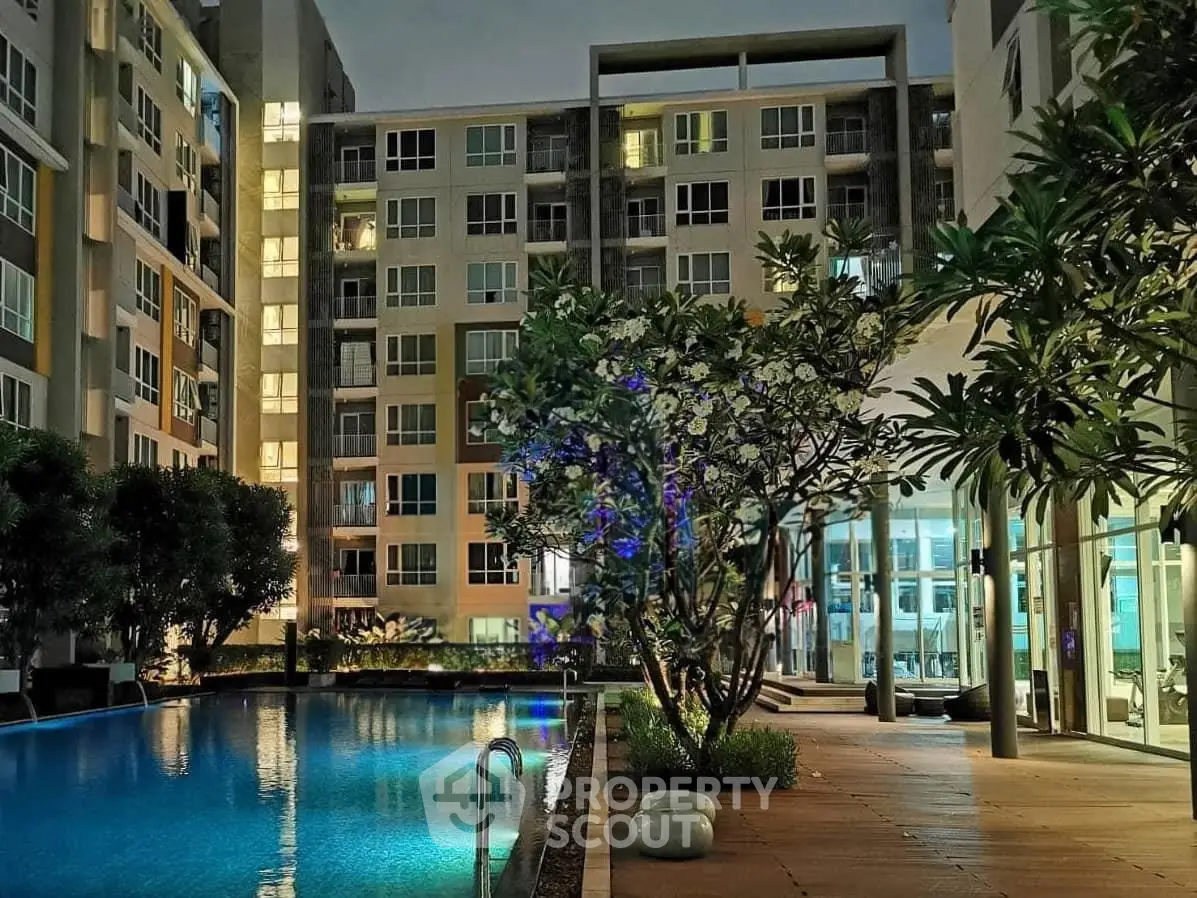 Luxurious condominium with illuminated pool and modern architecture at night