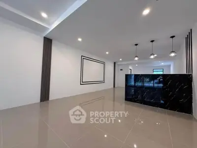 Spacious modern living room with elegant lighting and glossy tile flooring