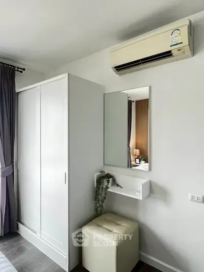 Modern bedroom with sleek wardrobe and air conditioning unit