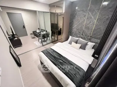 Modern bedroom with stylish decor and mirrored closet doors in a contemporary apartment.