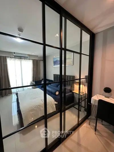 Modern bedroom with glass partition and cozy workspace