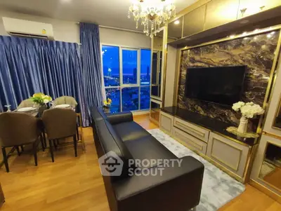 Luxurious living room with elegant decor and stunning city view at night.
