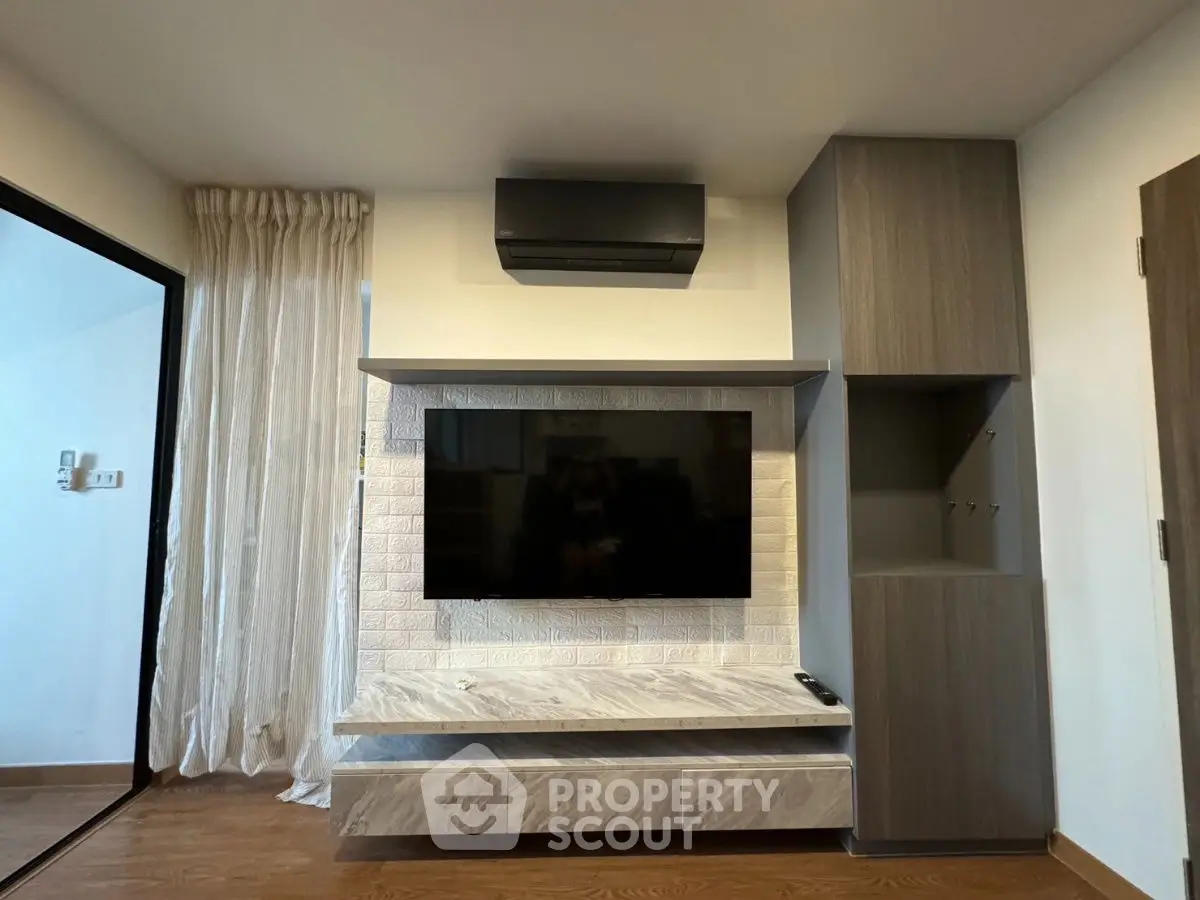 Modern living room with sleek TV setup and stylish cabinetry