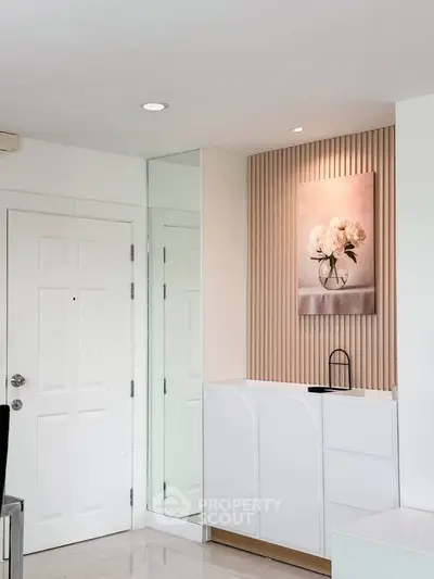 Modern interior with elegant decor and white cabinetry in a stylish living space.