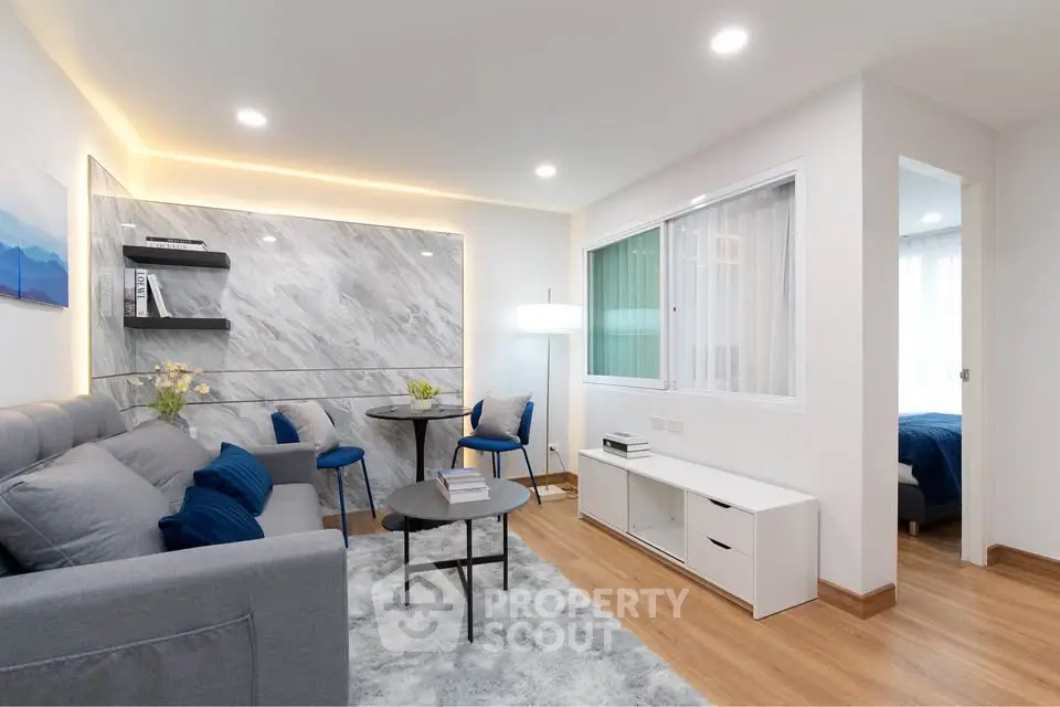 Modern living room with stylish decor and cozy ambiance in a contemporary apartment.