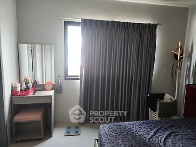 Cozy bedroom with modern decor and ample natural light