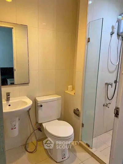 Compact bathroom with modern fixtures and glass shower enclosure