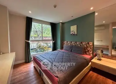 Cozy bedroom with large window and stylish decor in modern apartment