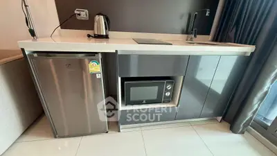 Modern compact kitchen with sleek appliances and stylish cabinetry